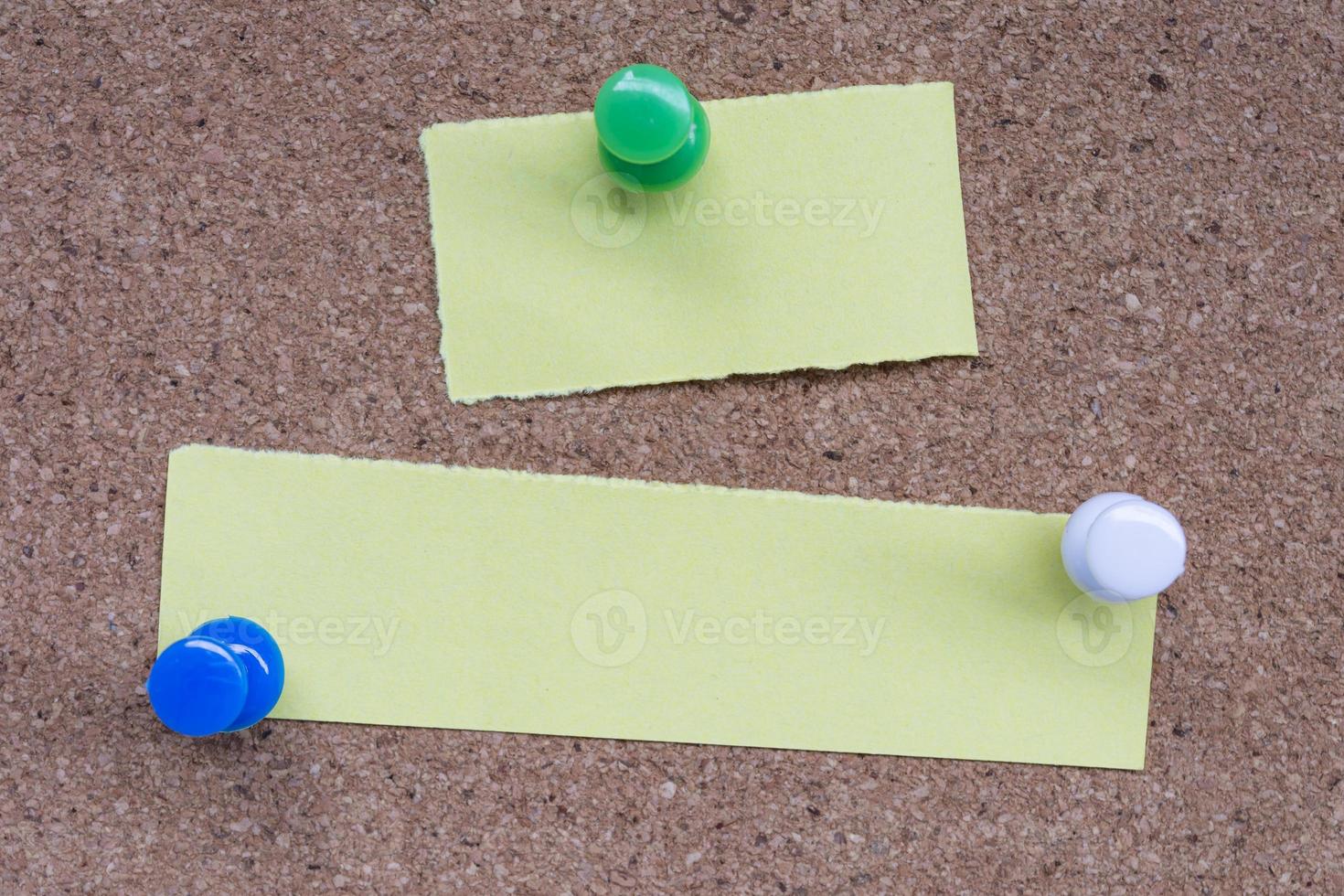Yellow stick note and pinned to a cork notice board. Copy space. photo