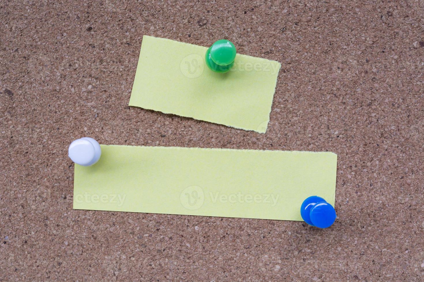 Yellow stick note and pinned to a cork notice board. Copy space. photo