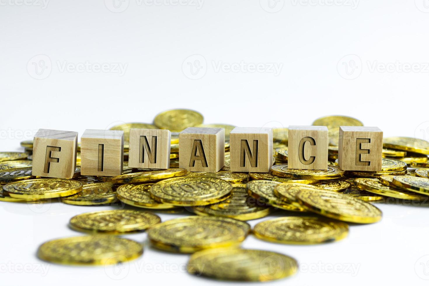 Financetext on wood block with a pile of gold coins. Business concept. photo