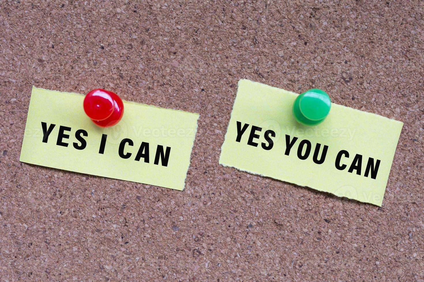Yes I Can and Yes You Can words on stick note and pinned to a cork notice board. photo