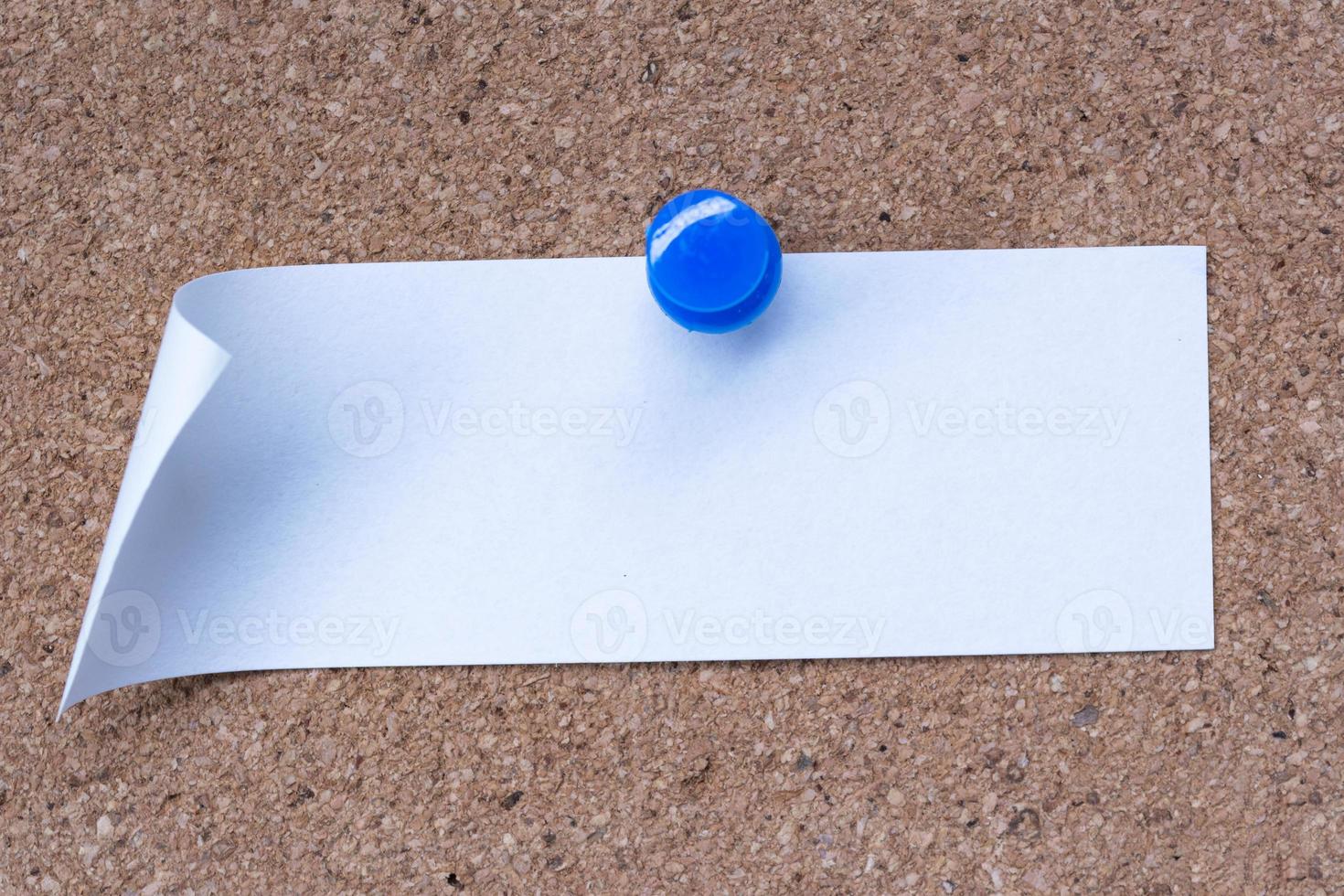 White stick note and pinned to a cork notice board. Copy space. photo