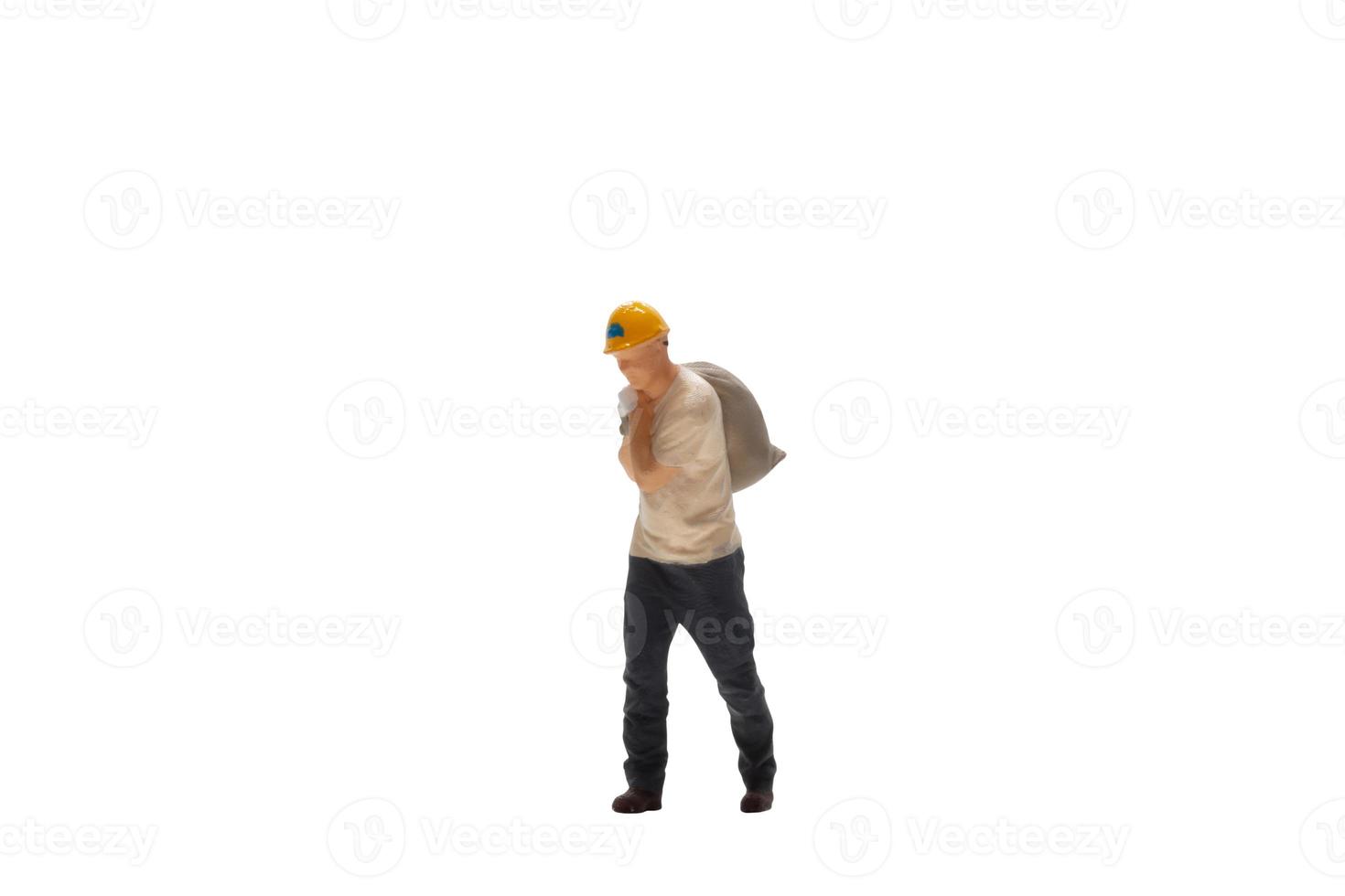 Miniature worker isolated on white background with clipping path photo