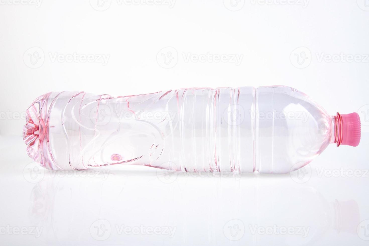 Plastic bottle of drinking water isolated on white photo