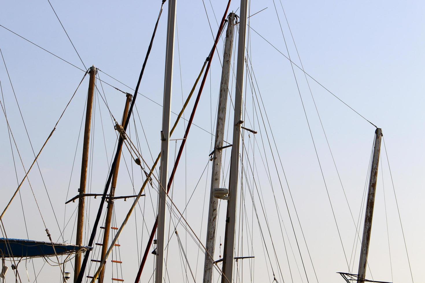 Tel Aviv Israel February 11, 2021. Ship masts against the blue sky. photo