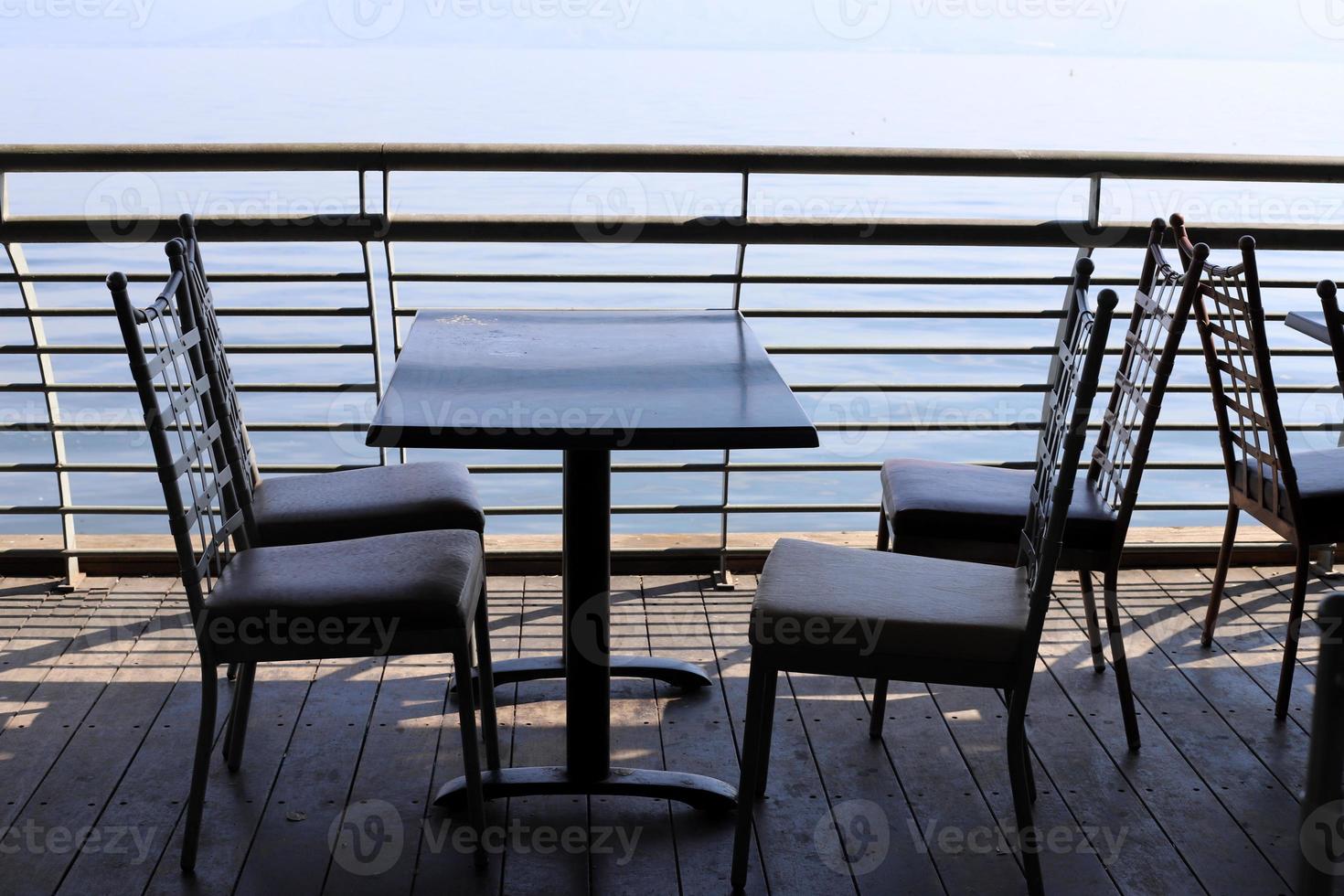 A chair in a city park on the seashore. photo