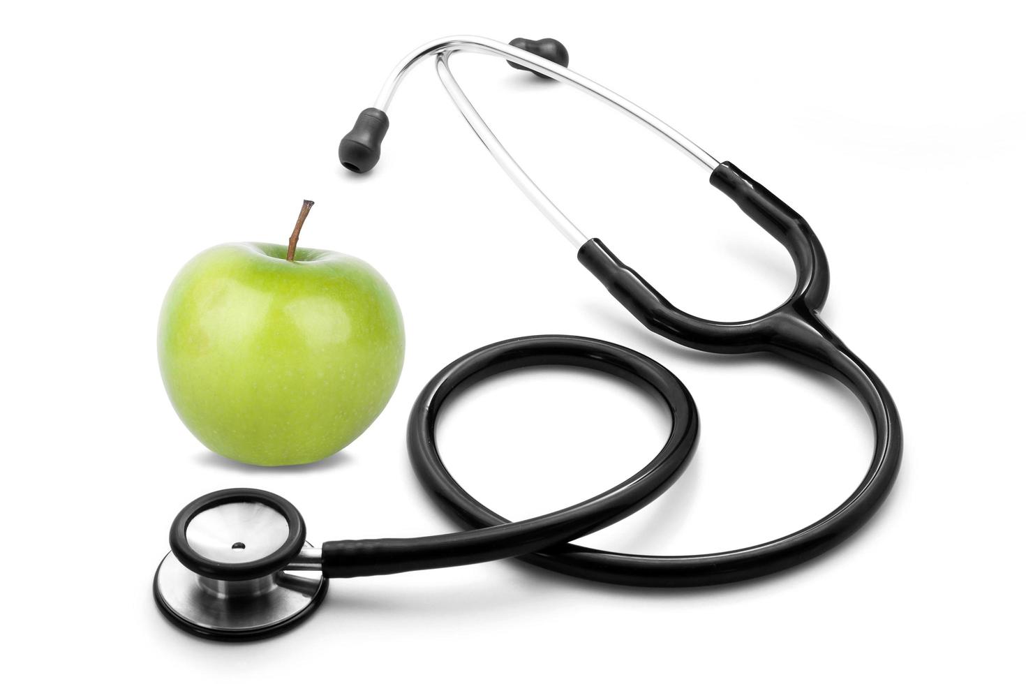 stethescope and apple on white background photo