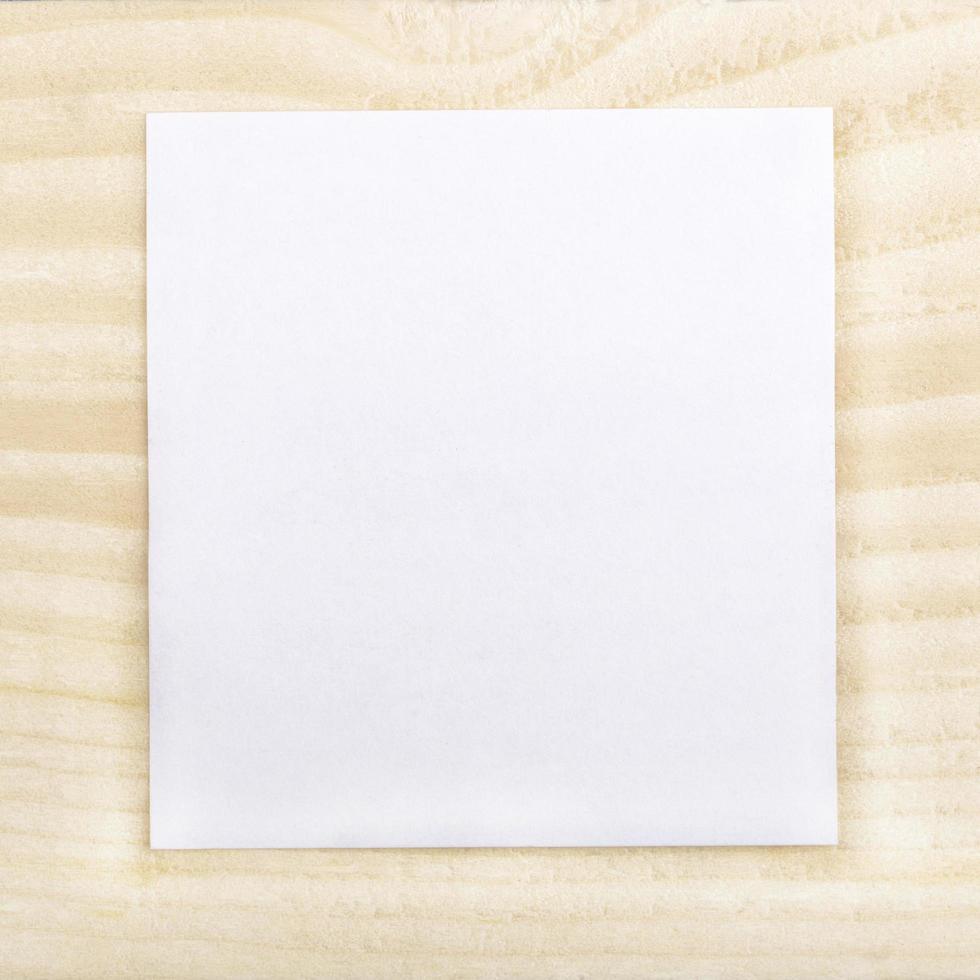 Blank paper on wood background photo