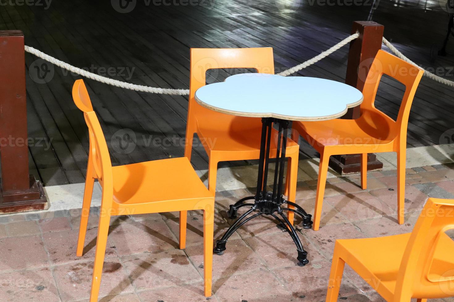 A chair in a city park on the seashore. photo