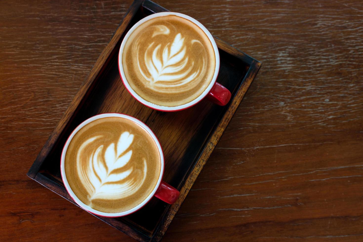 Top view latte art coffee in red cup photo