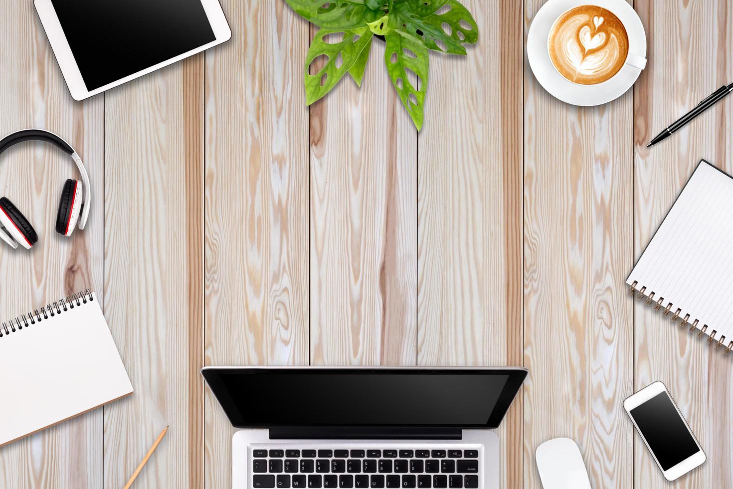 Modern workspace with laptop tablet, smartphone and coffee cup copy space on color background. Top view. Flat lay style. photo