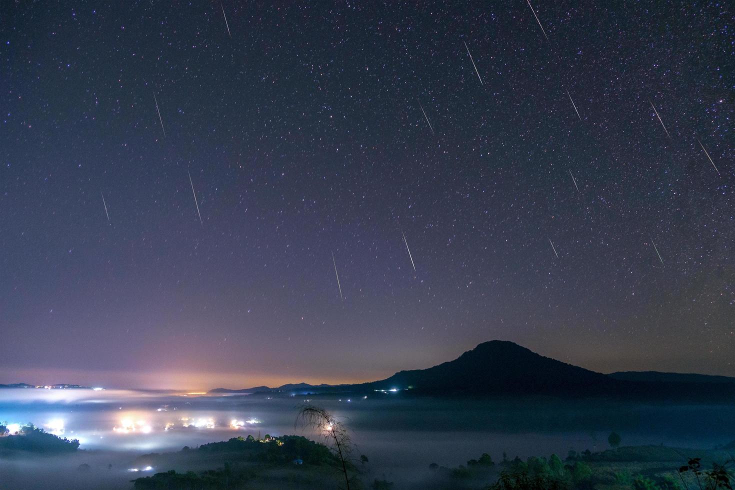 Geminid Meteor in the night sky with moon and fog at Khao Takhian Ngo View Point at Khao-kho Phetchabun,Thailand photo