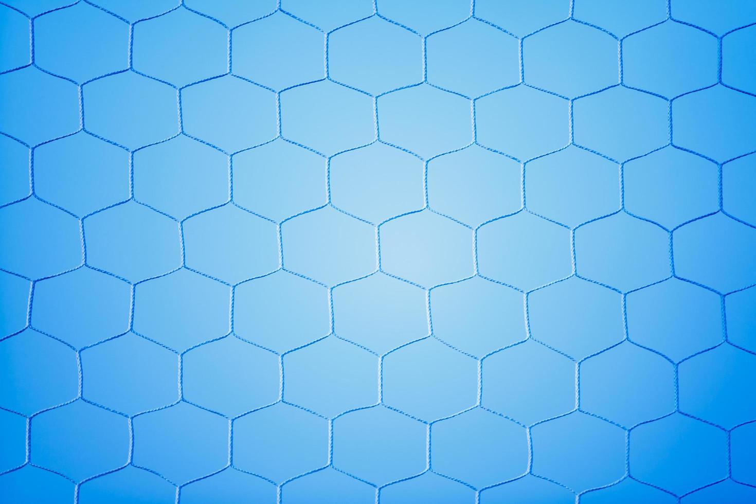 Soccer goal net with blue background photo