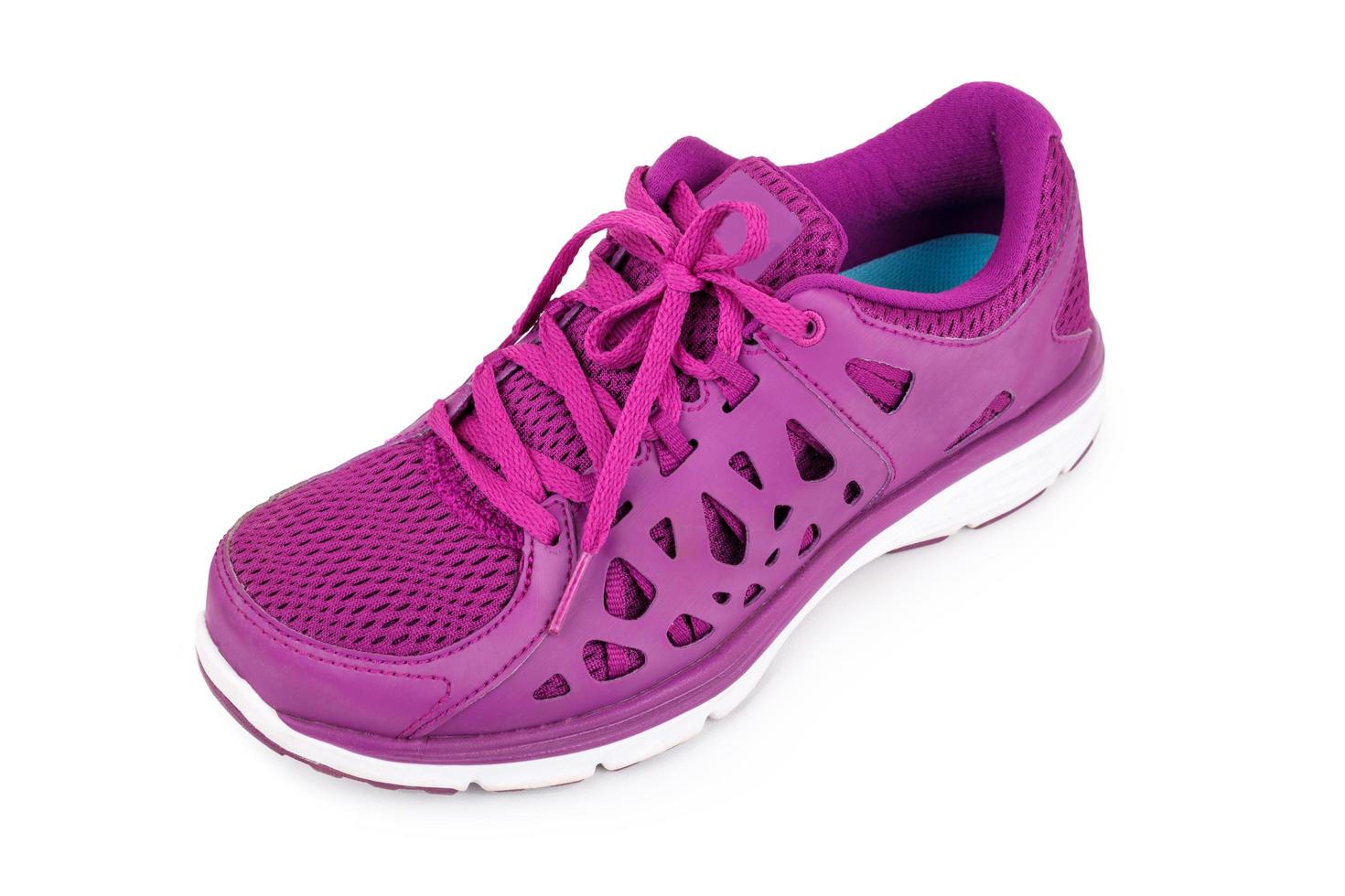 Violet sport running shoes isolated on white background photo