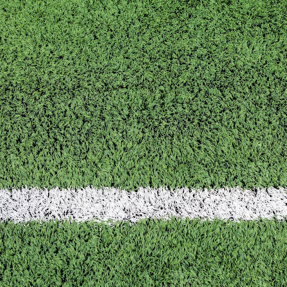 White stripe on the green football field photo