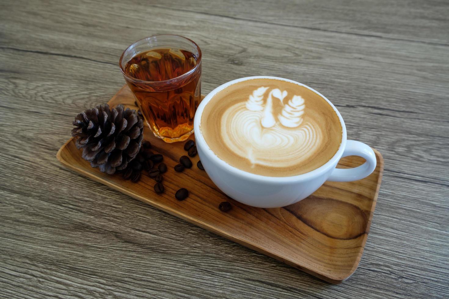 Coffee latte art and hot tea in coffee shop photo