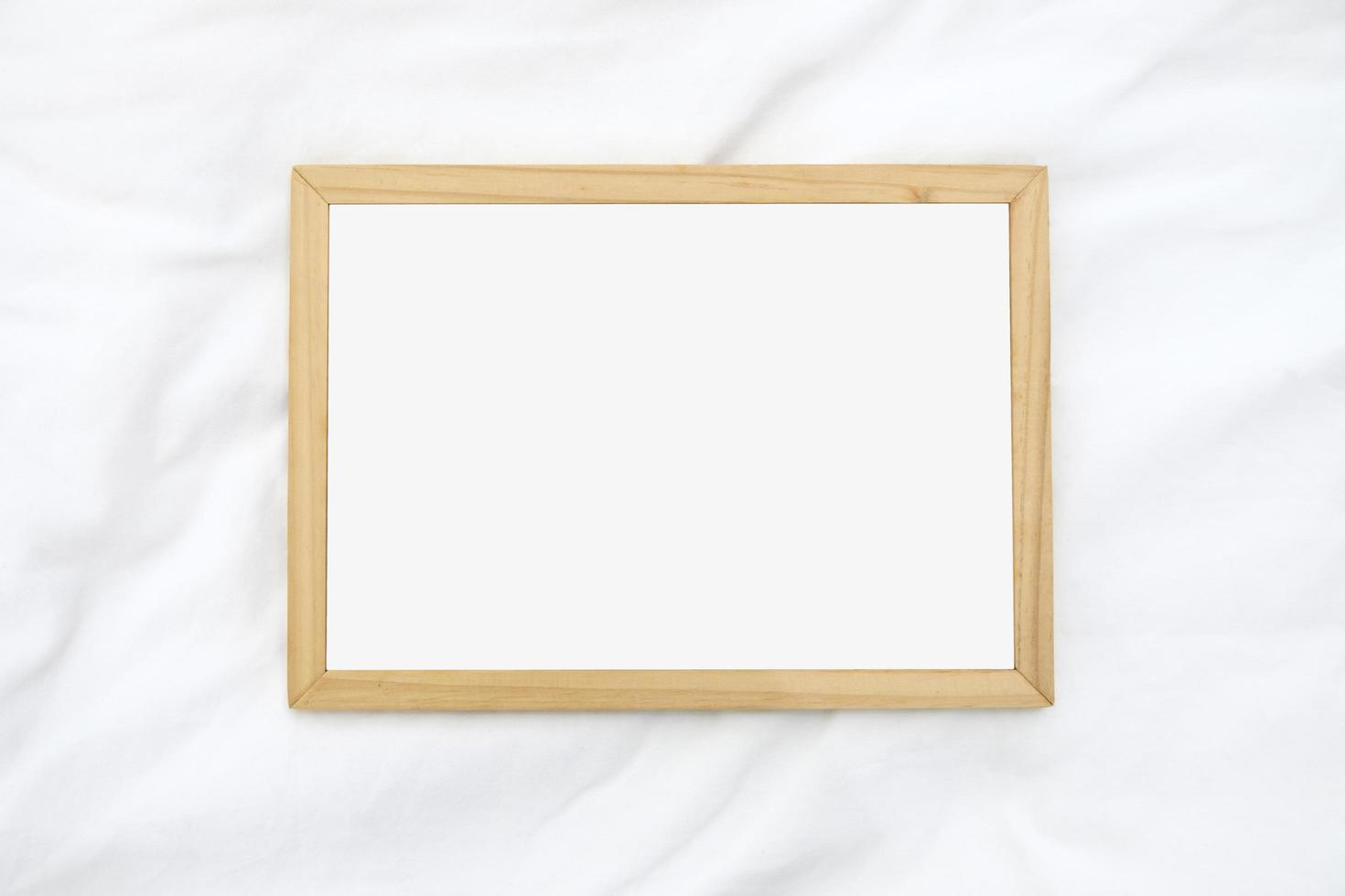 Wooden frame for photo on the fabric background