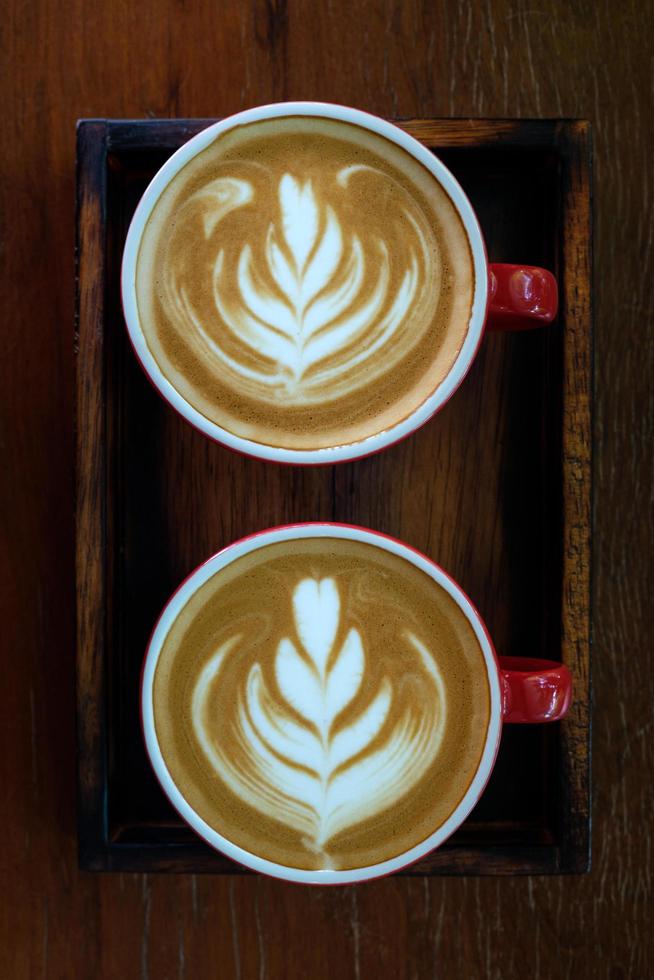 Top view latte art coffee in red cup photo