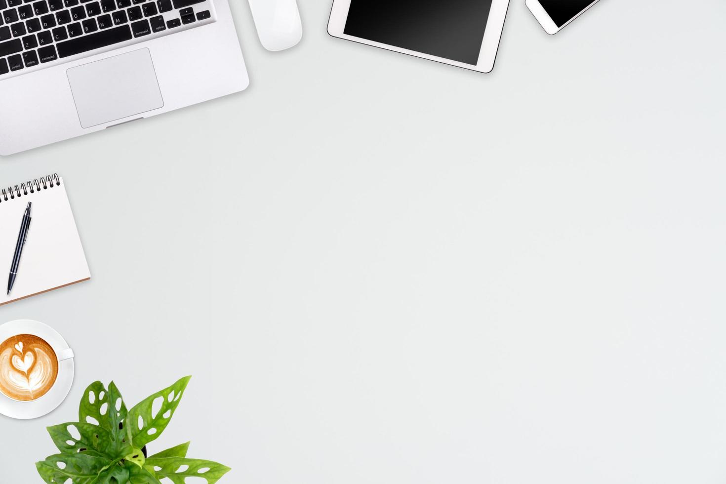 Modern workspace with laptop tablet, smartphone and coffee cup copy space on color background. Top view. Flat lay style. photo