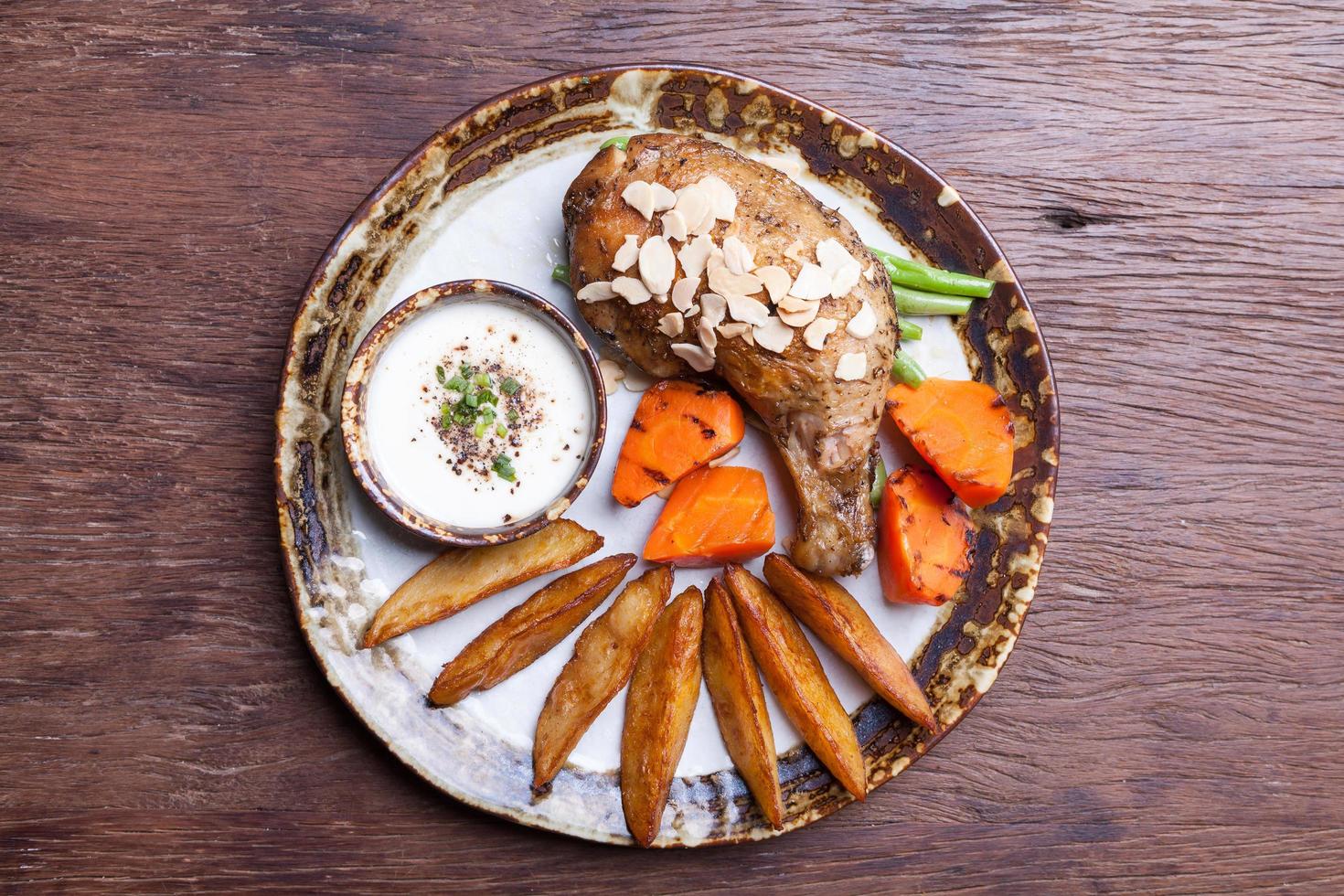 fried chicken drumsticks with french fries,carrot on  plate. top view photo