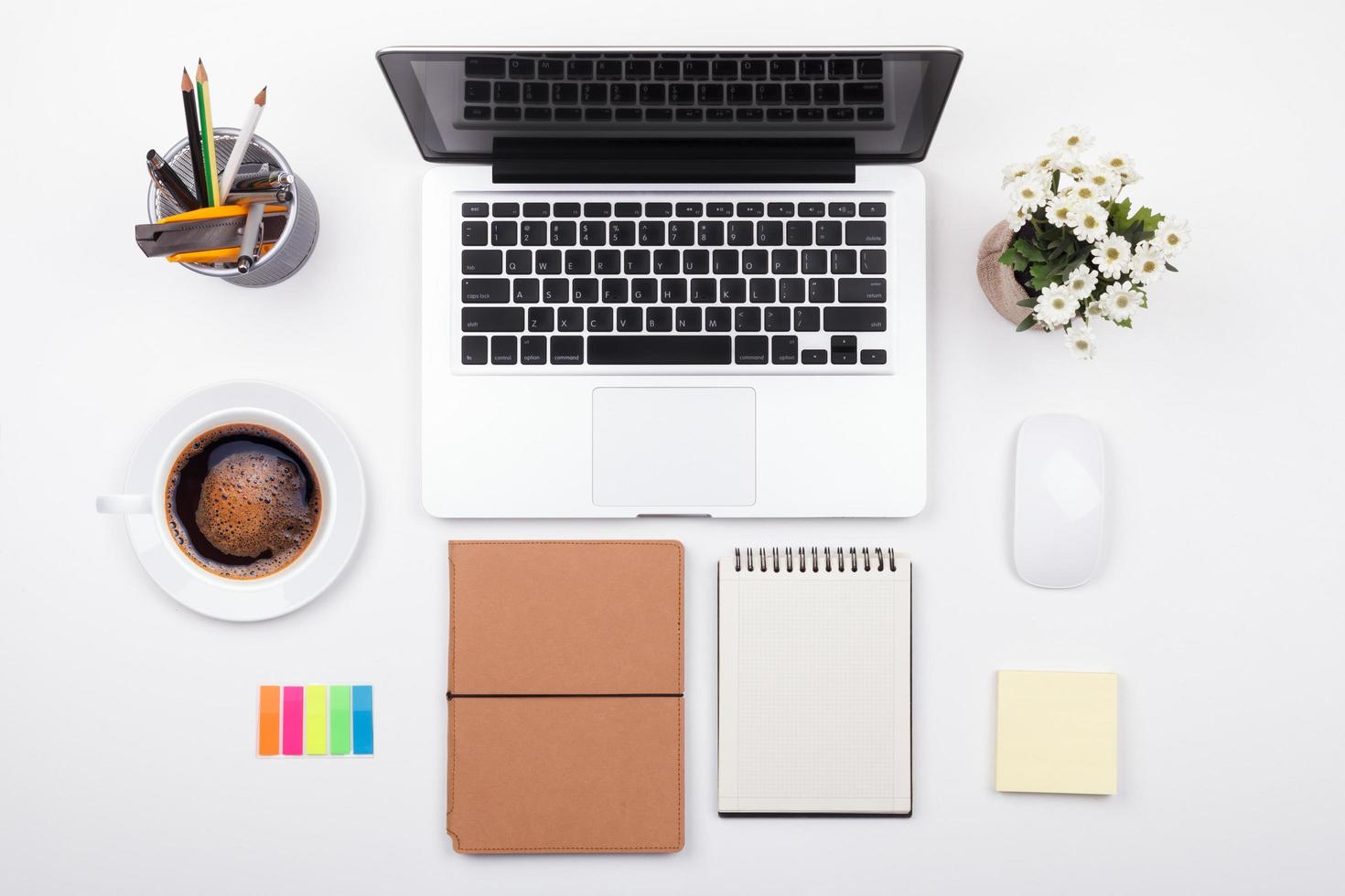 businessman's desk with laptop and office supplies on white background photo