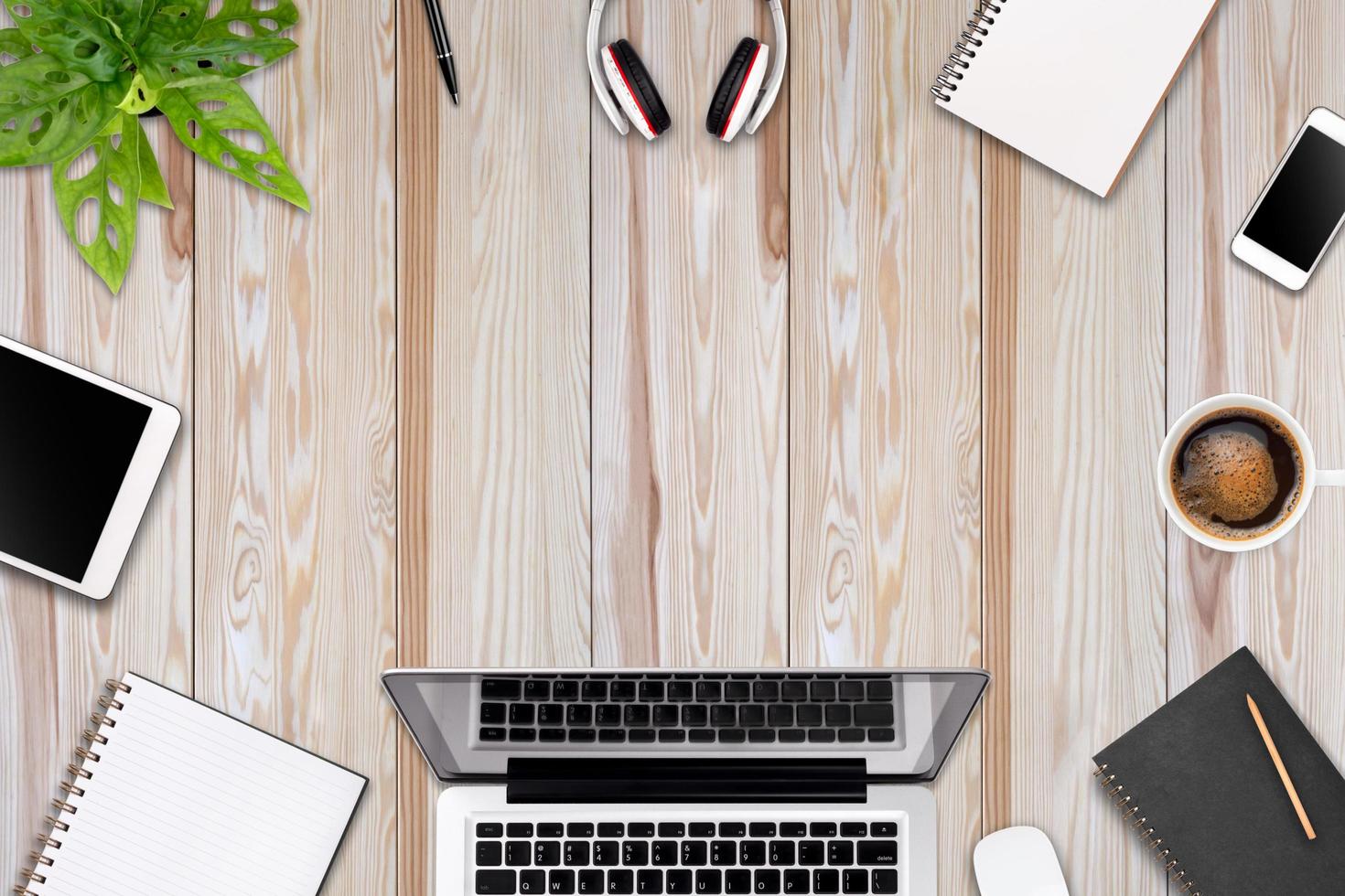 Modern workspace with laptop tablet, smartphone and coffee cup copy space on color background. Top view. Flat lay style. photo