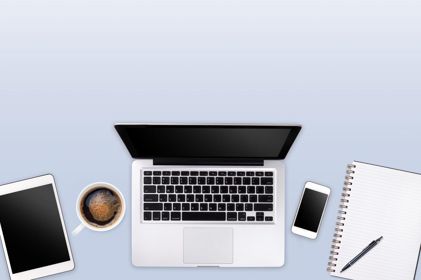 Modern workspace with laptop tablet, coffee cup and smartphone copy space on color background. Top view. Flat lay style. photo