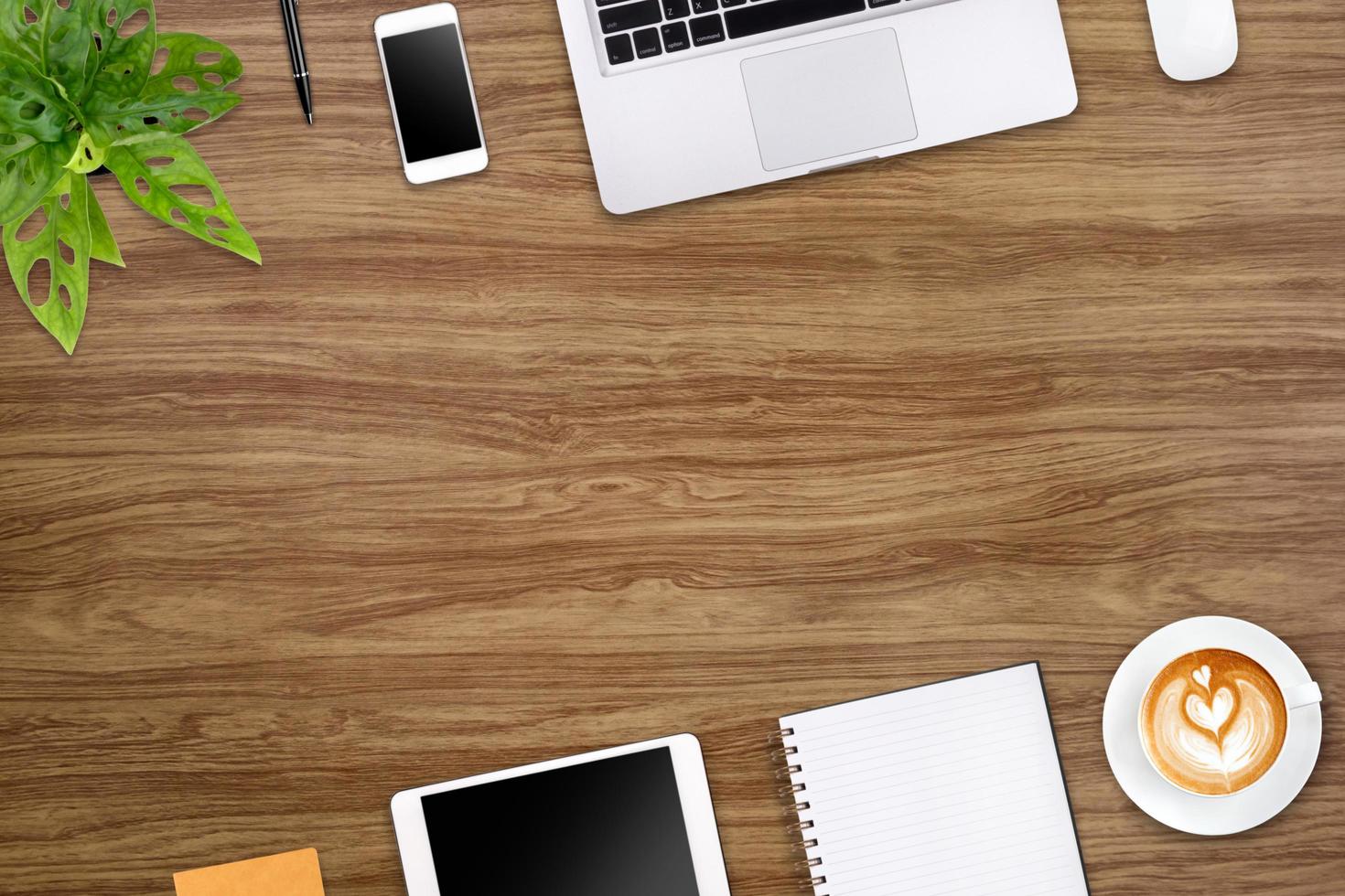 Modern workspace with laptop tablet, smartphone and coffee cup copy space on wood background. Top view. Flat lay style. photo