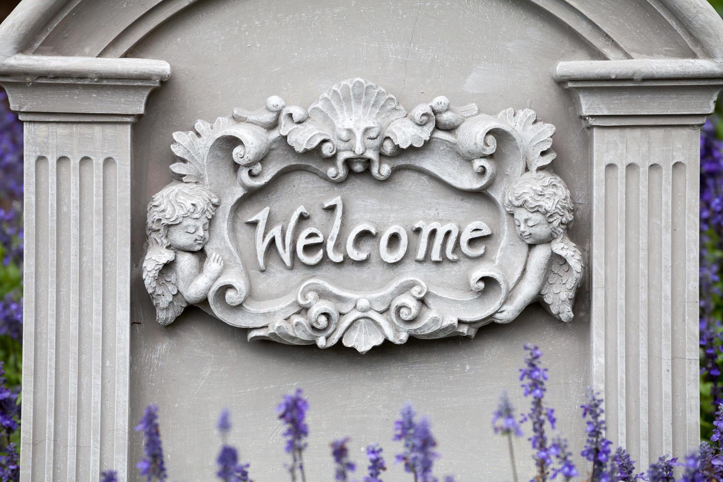 Welcome sign on stone background with lavender flower photo