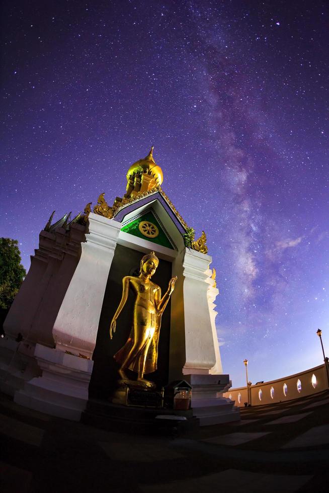 Milky Way at Standing gold Buddha image name is Wat Sra Song Pee Nong in Phitsanulok, Thailand photo