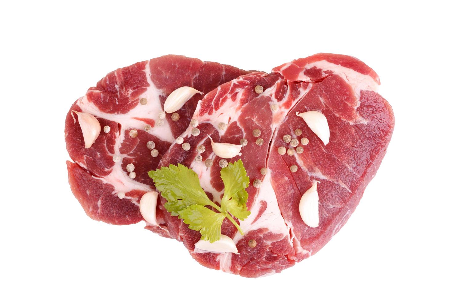 raw steaks of pork neck seasoned with pepper and garlic photo