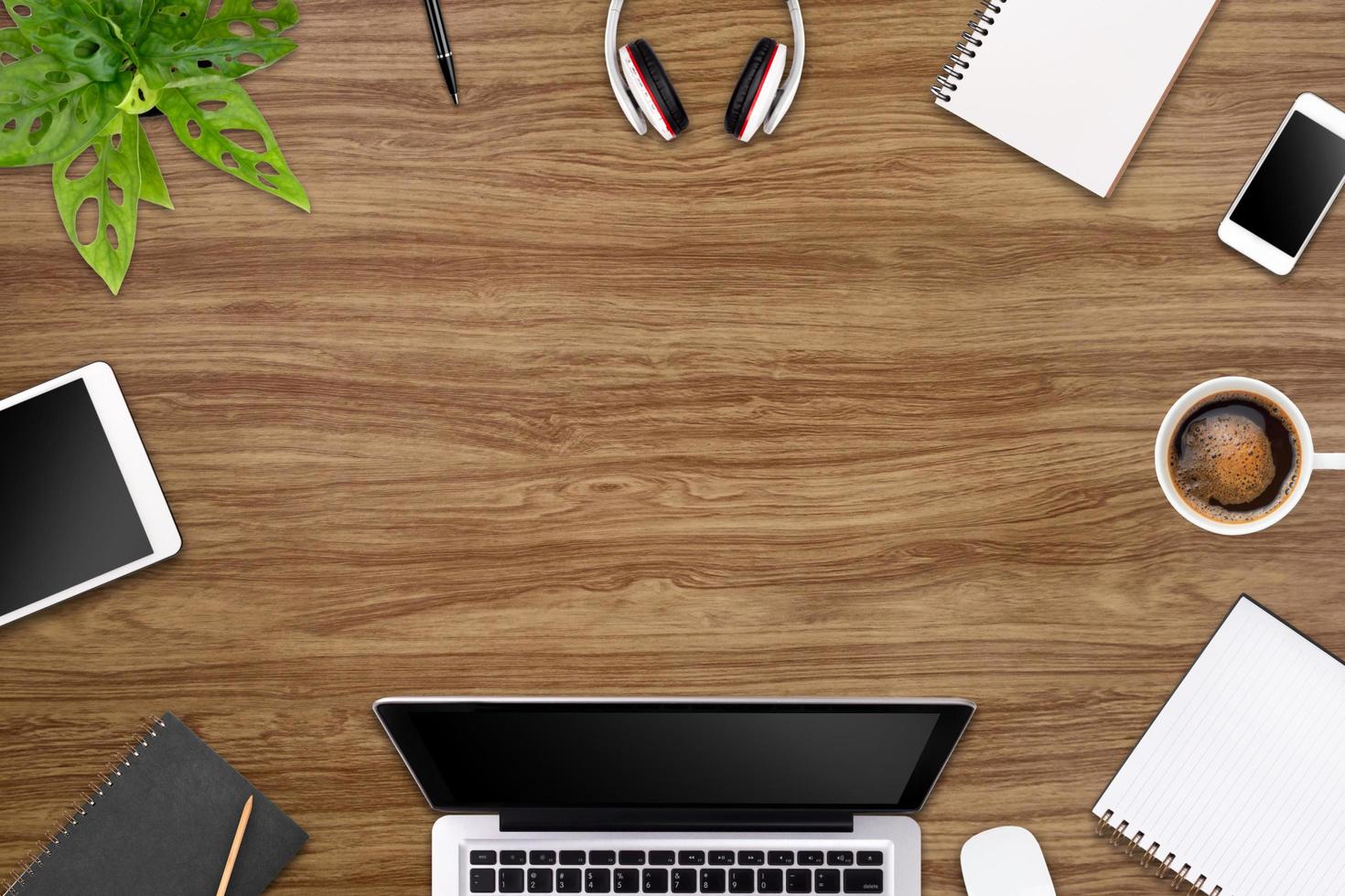 Modern workspace with laptop tablet, smartphone and coffee cup copy space on color background. Top view. Flat lay style. photo