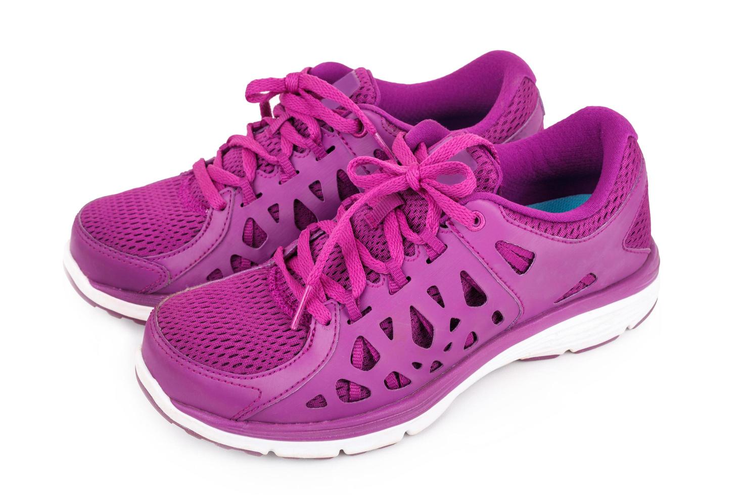 Violet sport running shoes isolated on white background photo