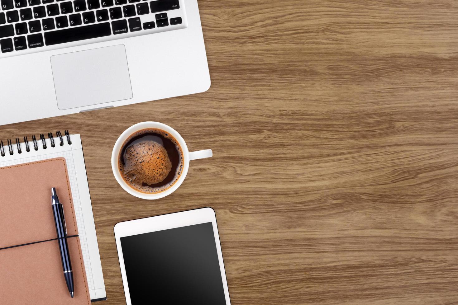 Modern workspace with laptop tablet,notebook and coffee cup copy space on wood table background. Top view. Flat lay style. photo