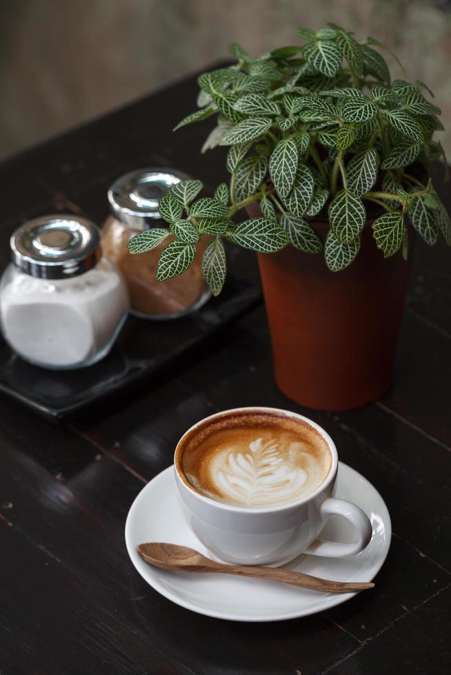 Cup of latte coffee on wooden table photo