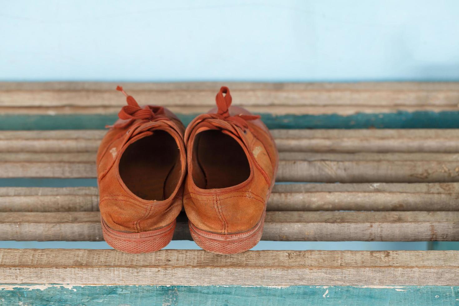 Old children sneakers a wooden background photo