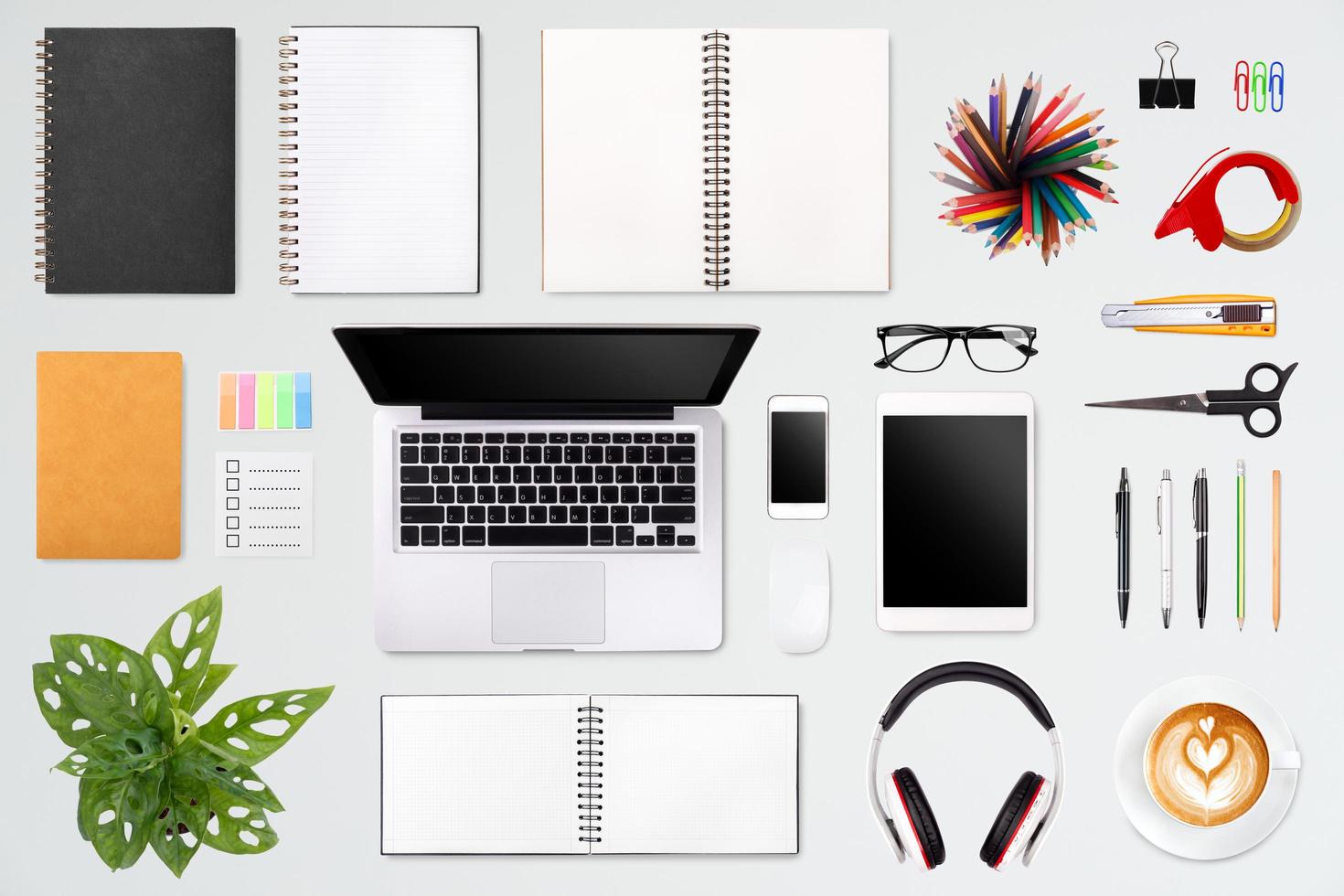 Modern workspace with laptop tablet, smartphone and coffee cup copy space on color background. Top view. Flat lay style. photo