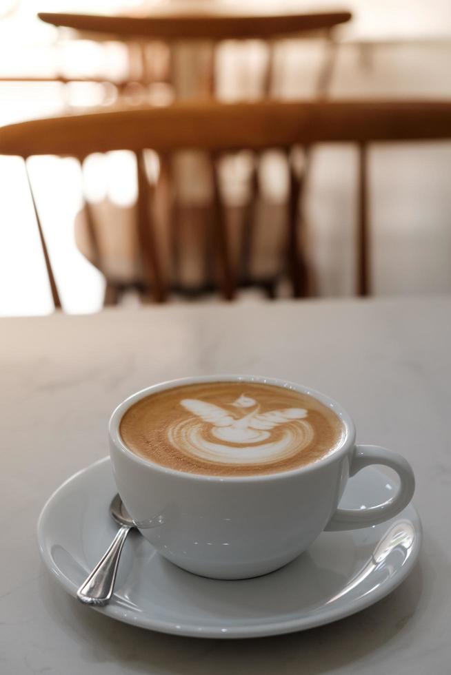 Coffee latte art in coffee shop in vintage color filter photo