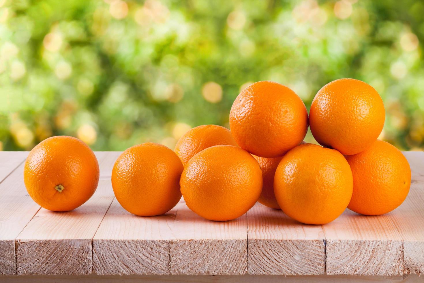 Fresh orange on wood with blur bokeh background photo