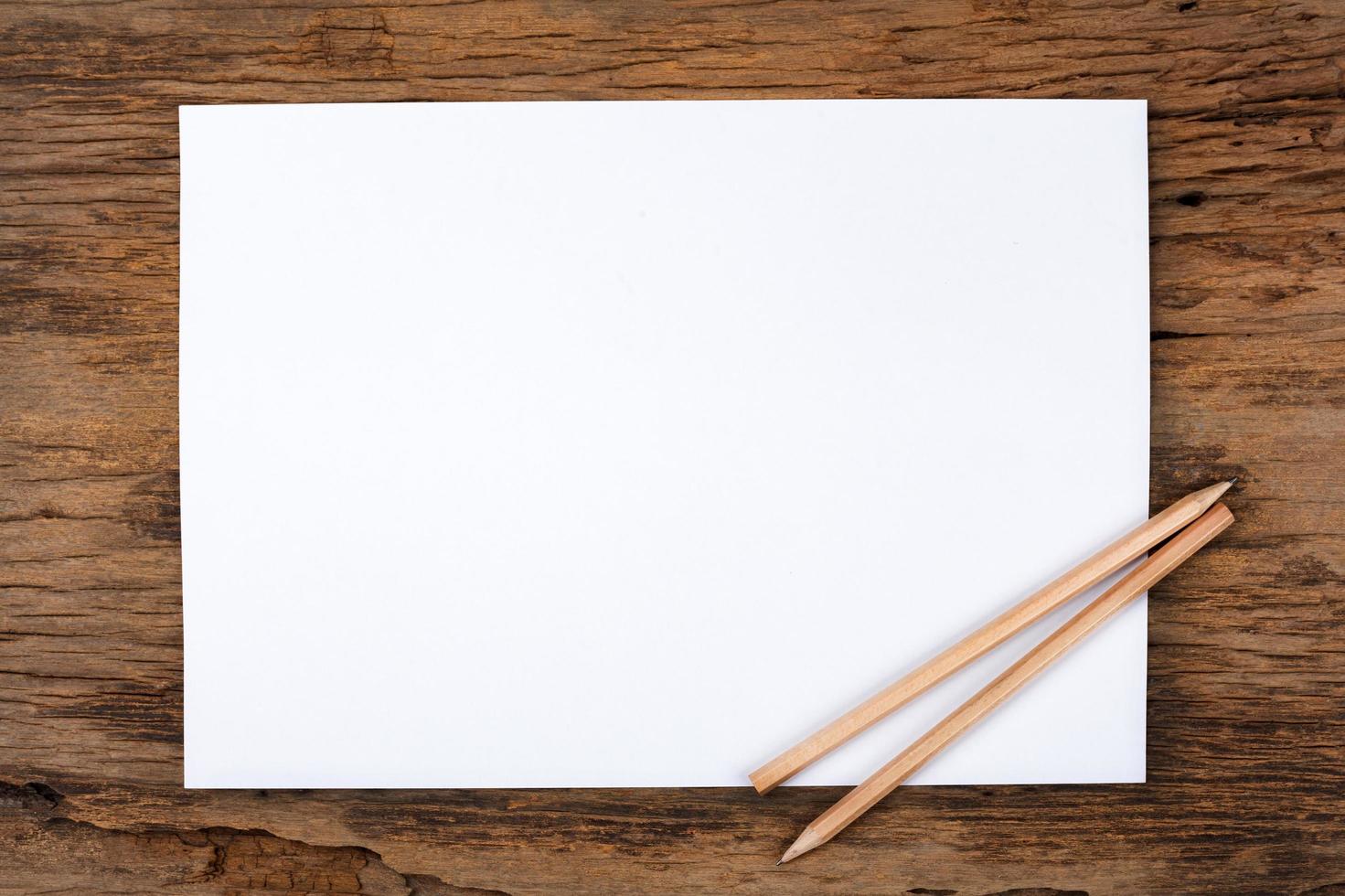 papel blanco con lápiz sobre mesa de madera foto