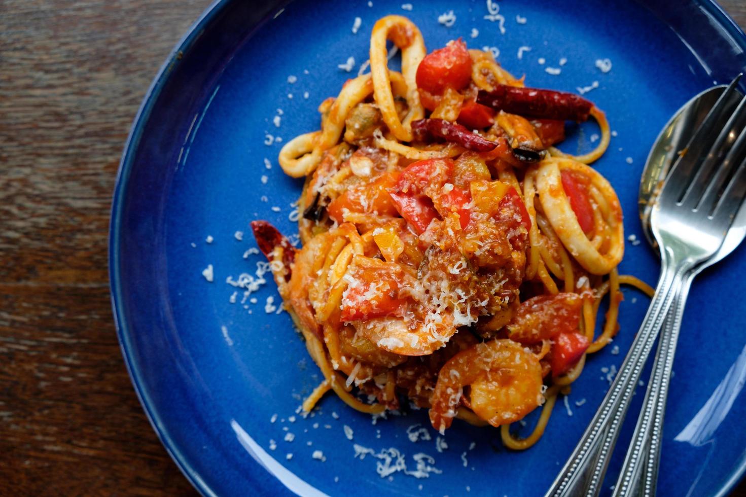 spaghetti seafood tomato sauce on wood table photo