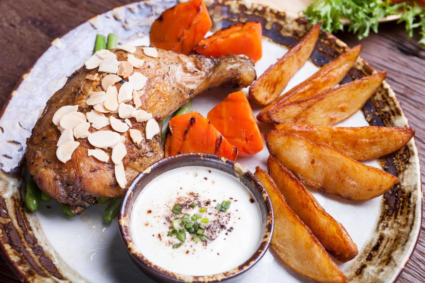 fried chicken drumsticks with french fries,carrot on plate. photo