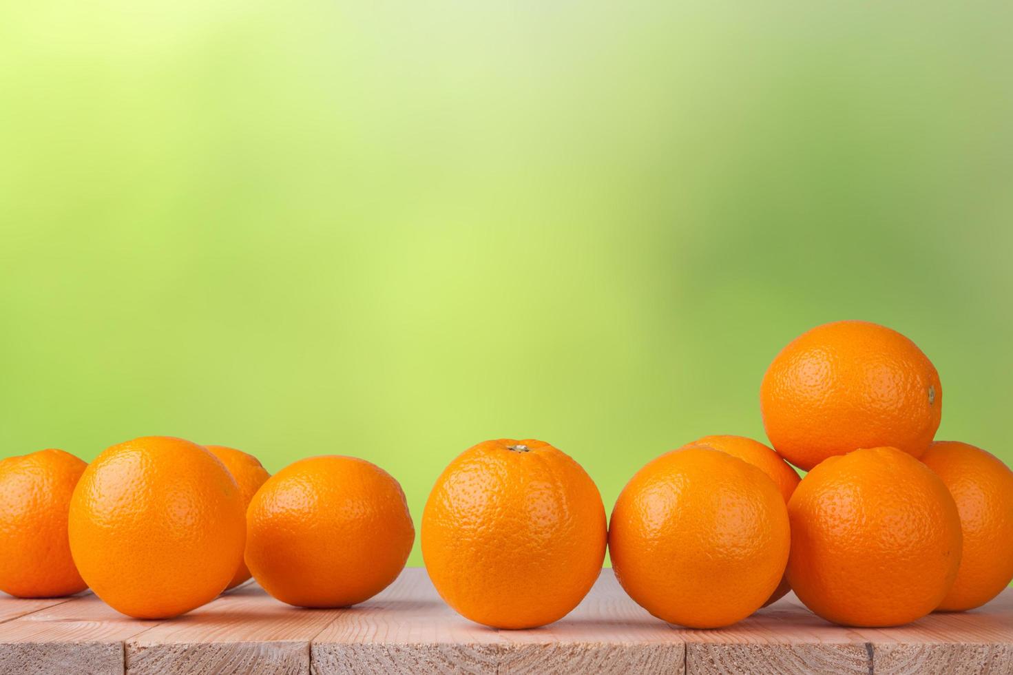 Fresh orange on wood table with blur bokeh background photo