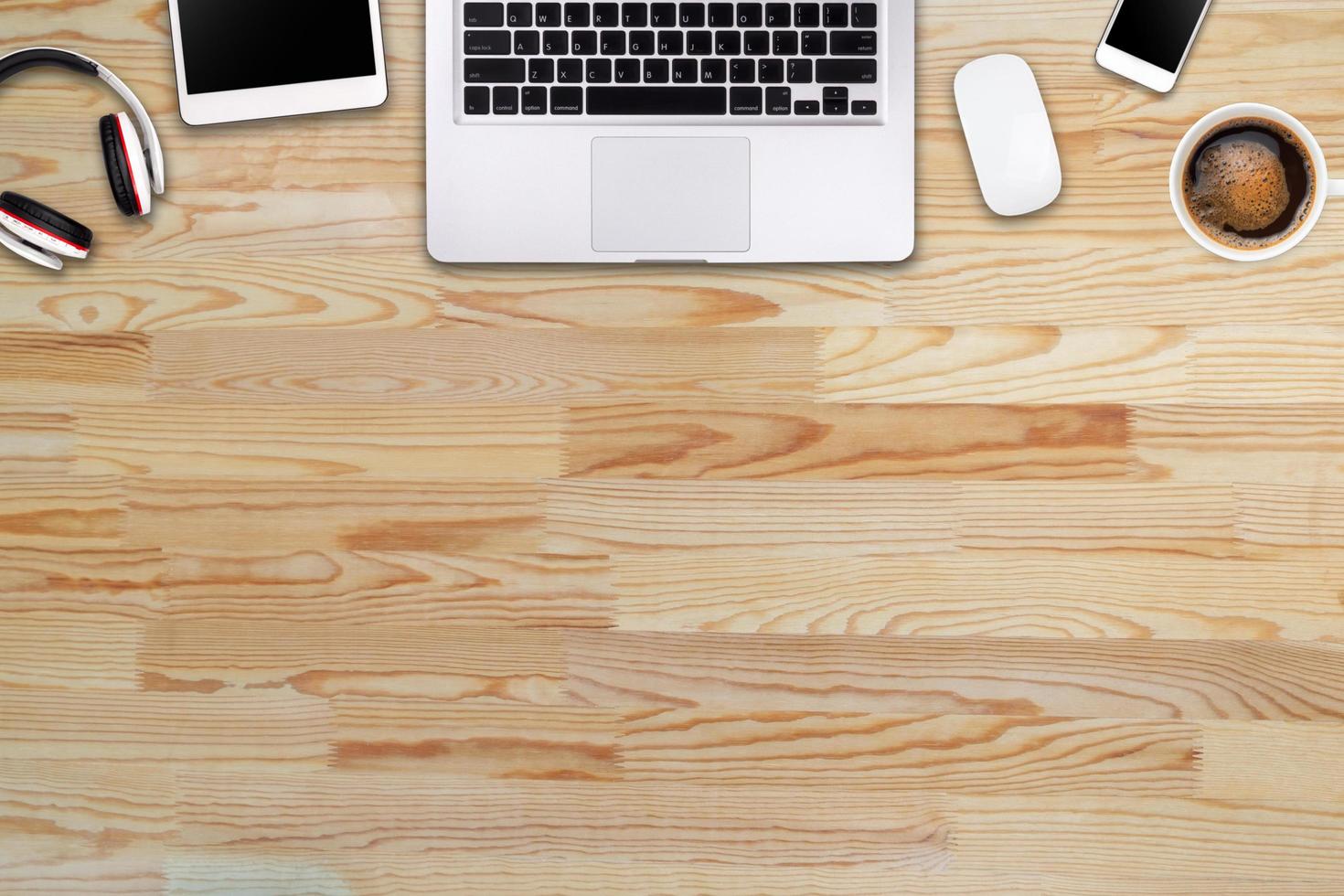 Modern workspace with laptop tablet, smartphone and coffee cup copy space on wood background. Top view. Flat lay style. photo