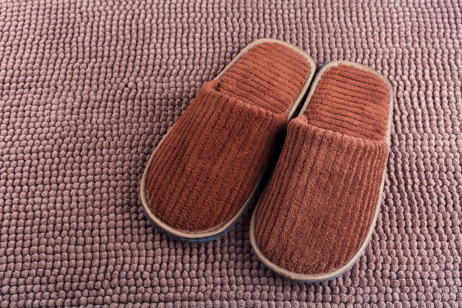Brown wool slipper on mat photo