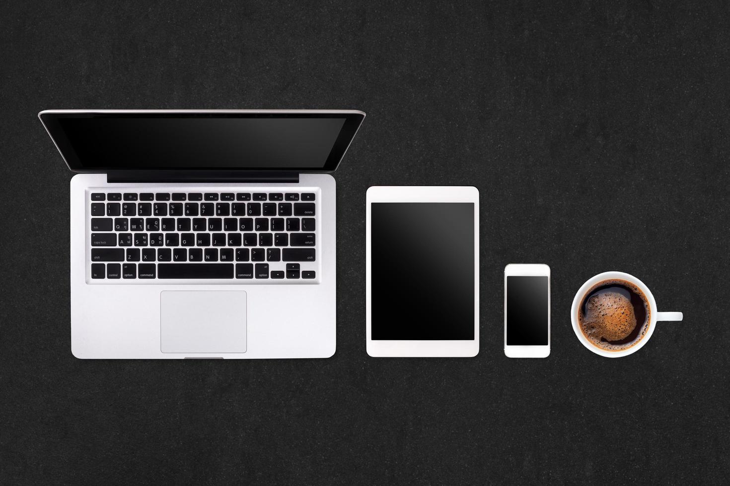 Laptop tablet smartphone  and coffee on rock table background with text space and copy space photo