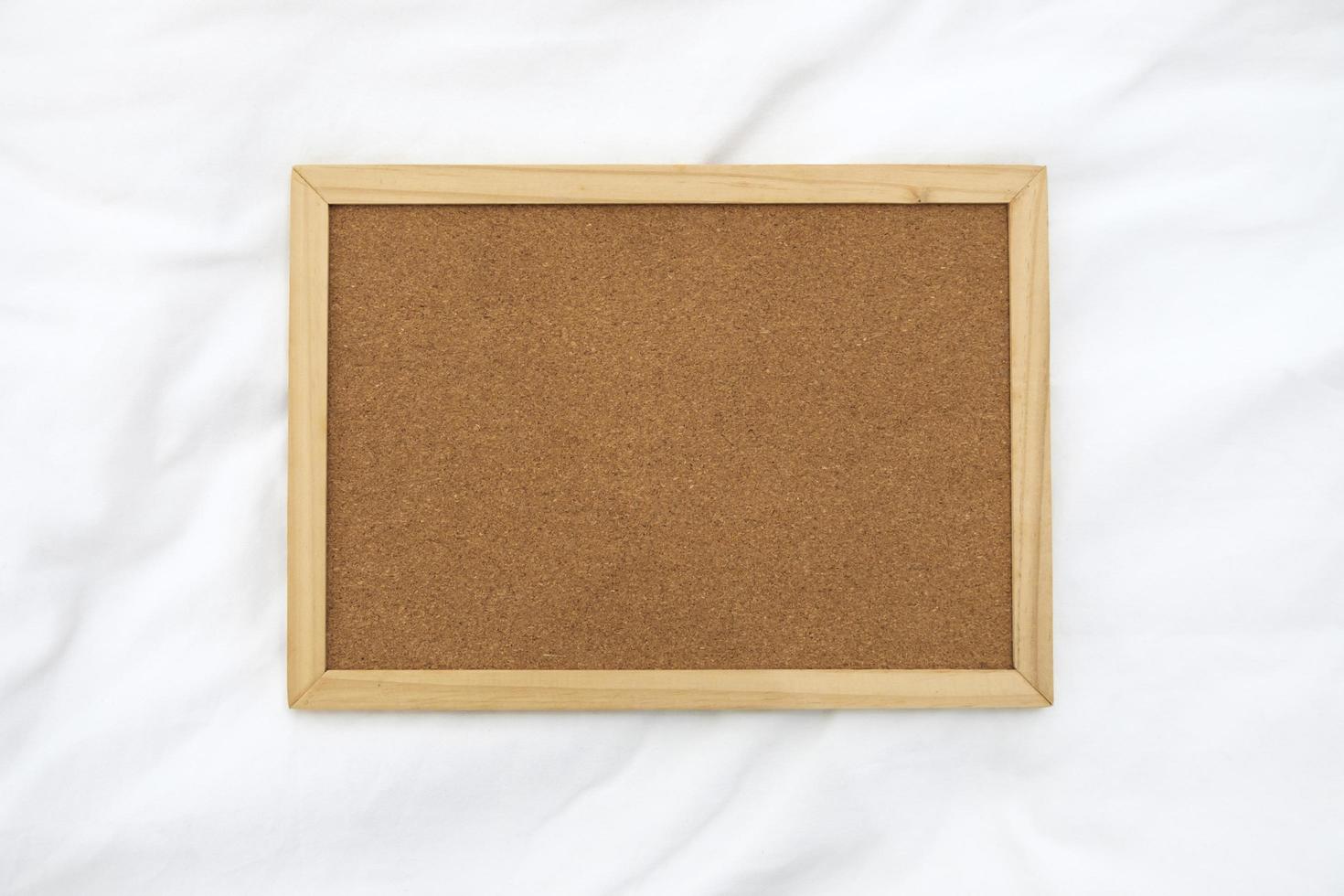 Wooden frame for photo on the fabric background