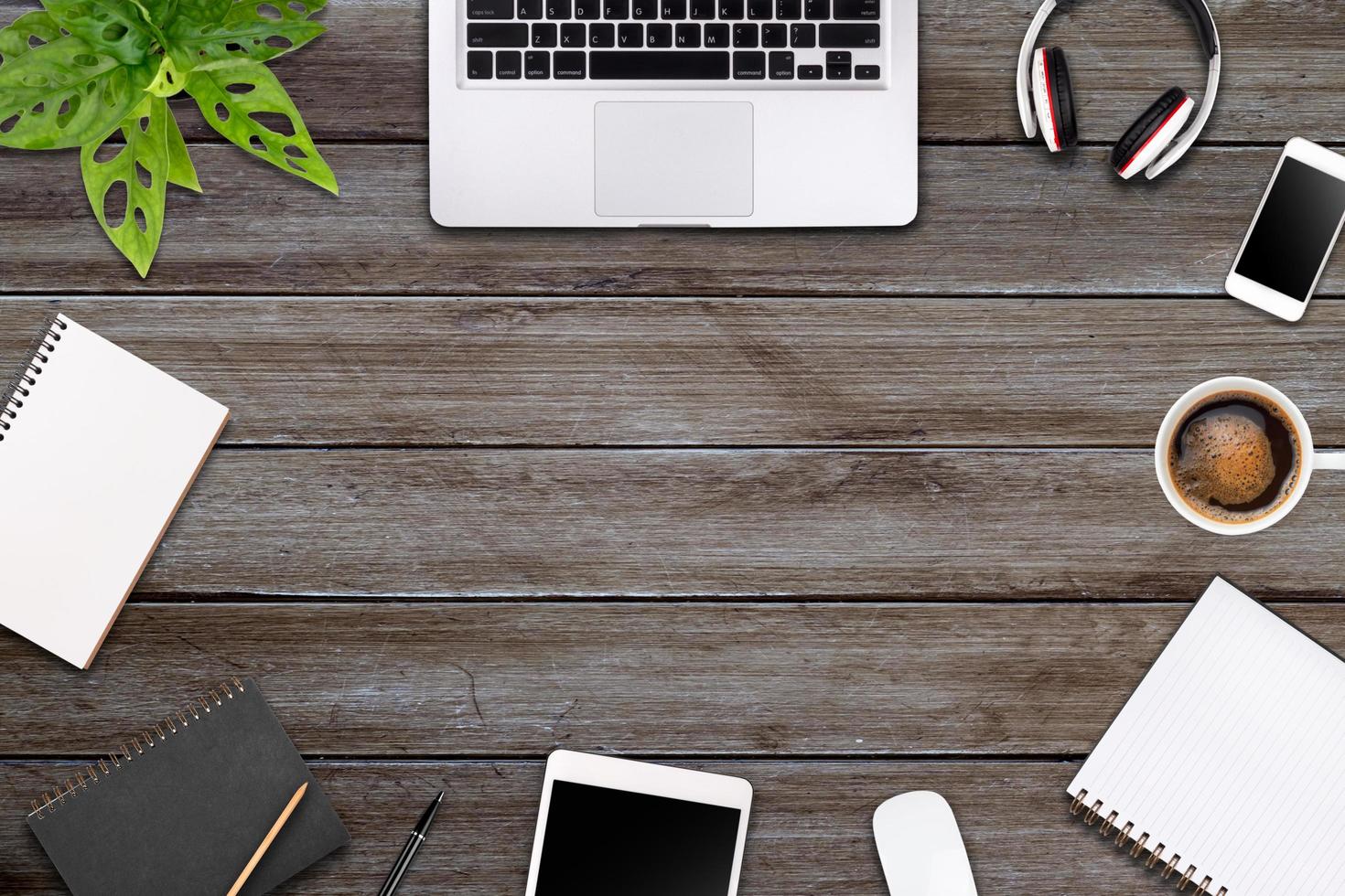 Modern workspace with laptop tablet, smartphone and coffee cup copy space on color background. Top view. Flat lay style. photo