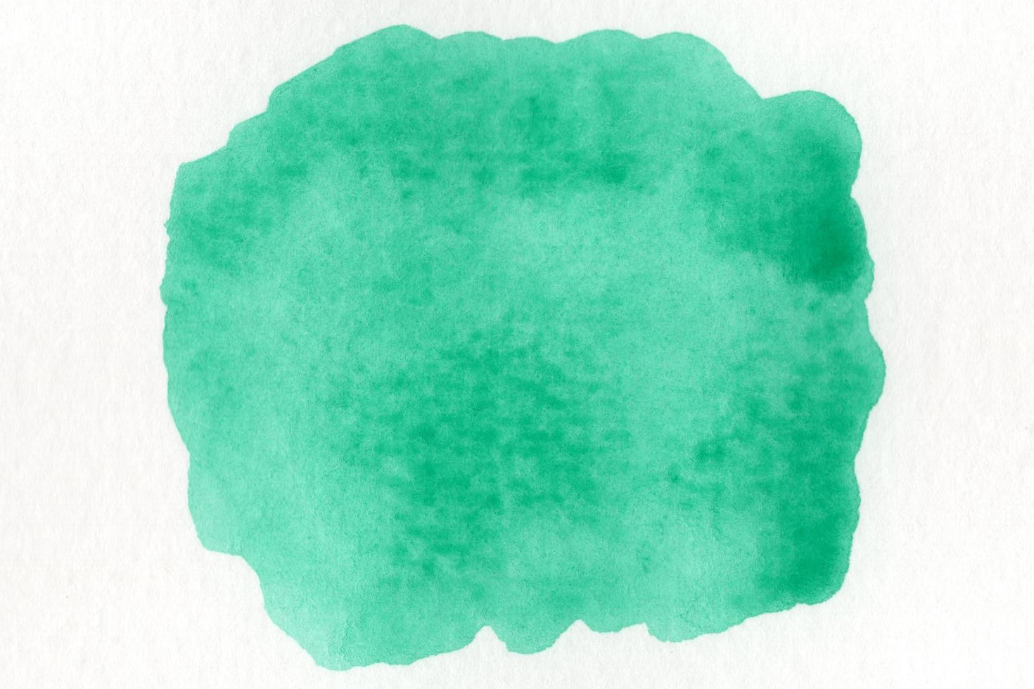 Abstract green watercolor on white background.The color splashing on the paper.It is a hand drawn. photo