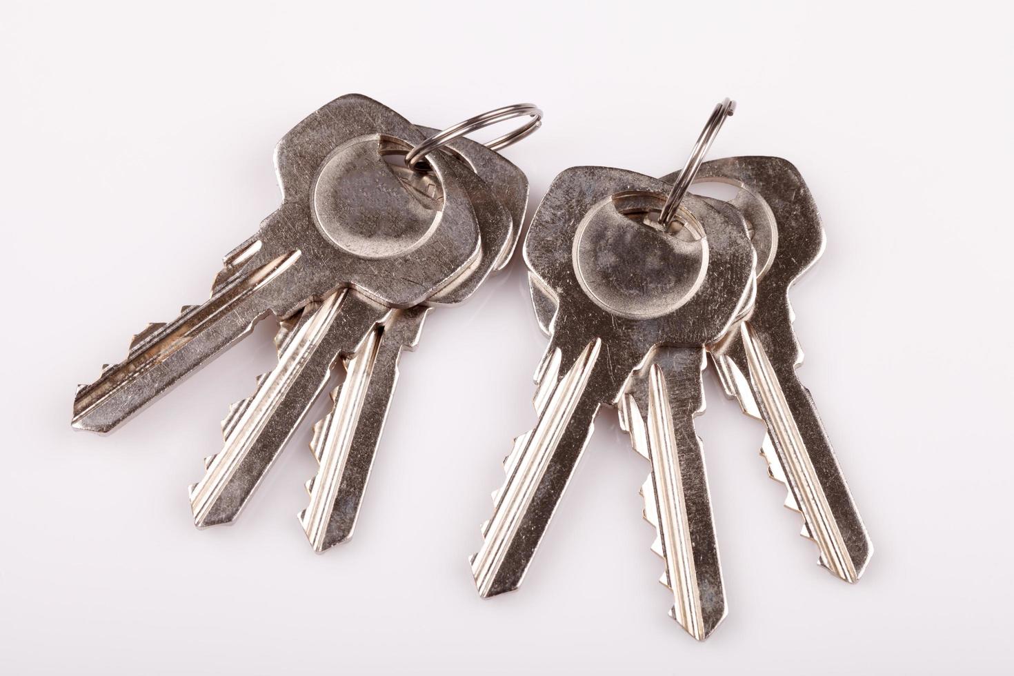 Set of old house keys  on white background photo