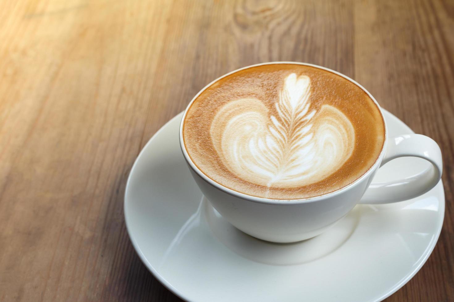 Coffee latte art in coffee shop in vintage color filter photo